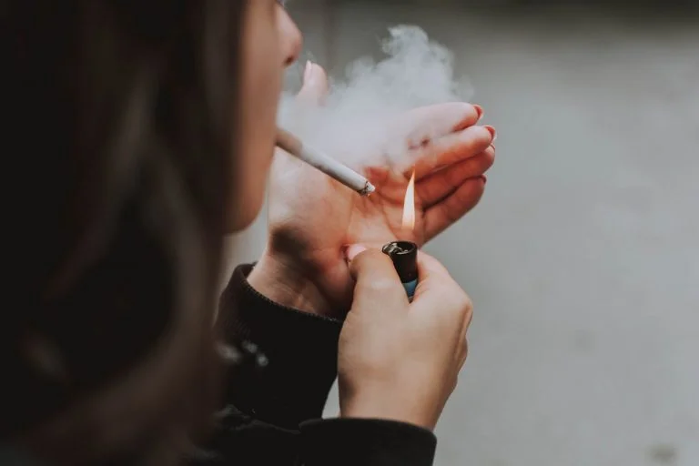 a person holding a cigarette