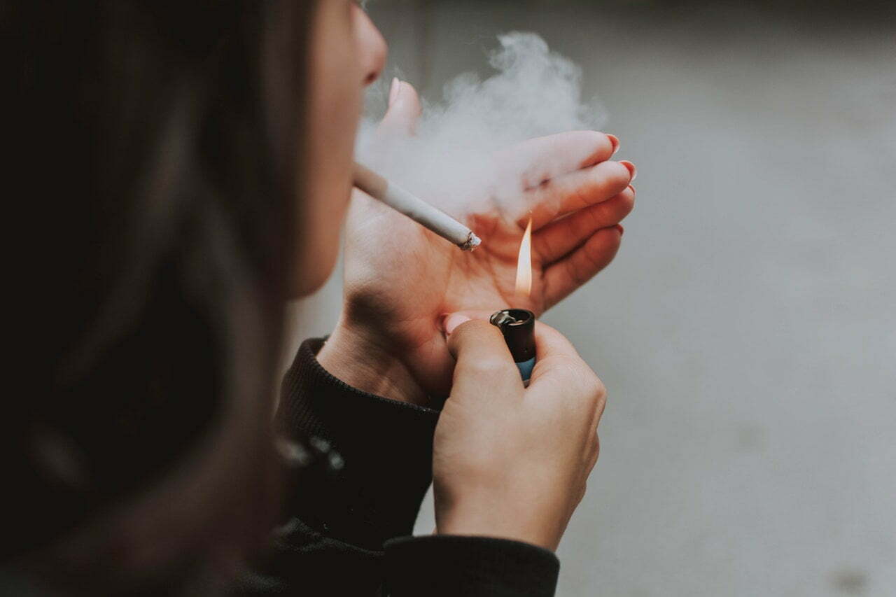 a person holding a cigarette