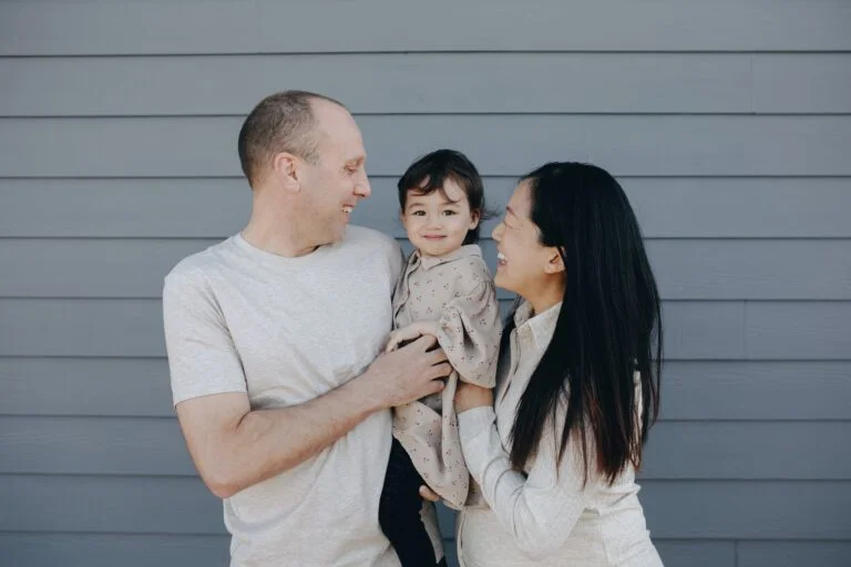 a man and woman holding a baby