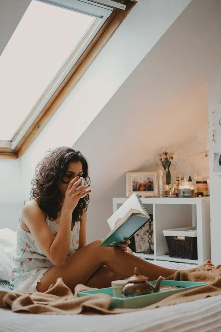 a woman sitting on a bed