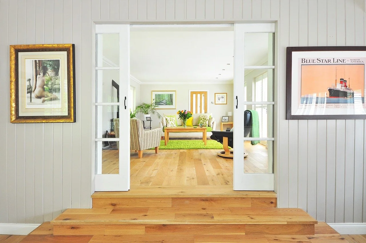 a room with a wood floor and a painting on the wall