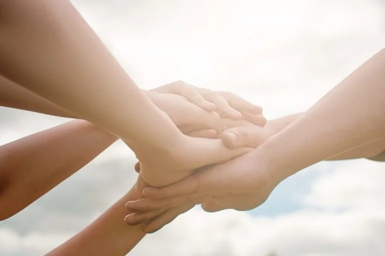 a few hands holding each other