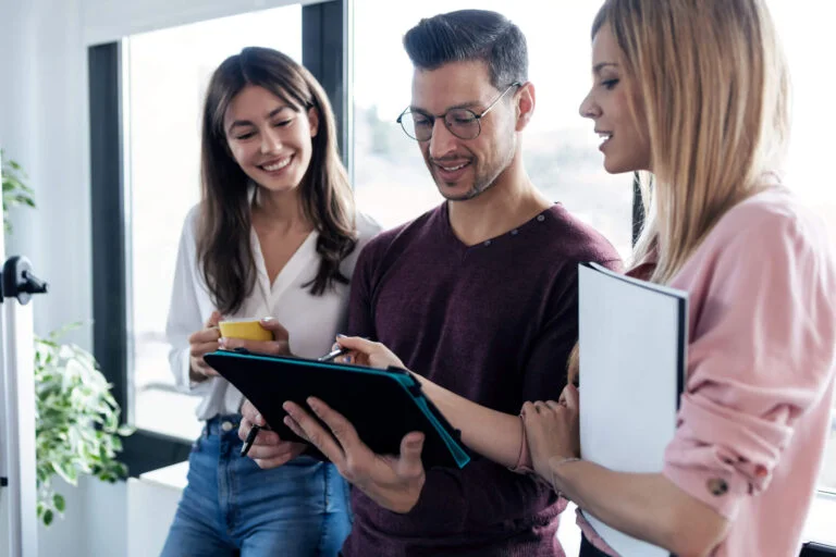 a group of people holding a tablet