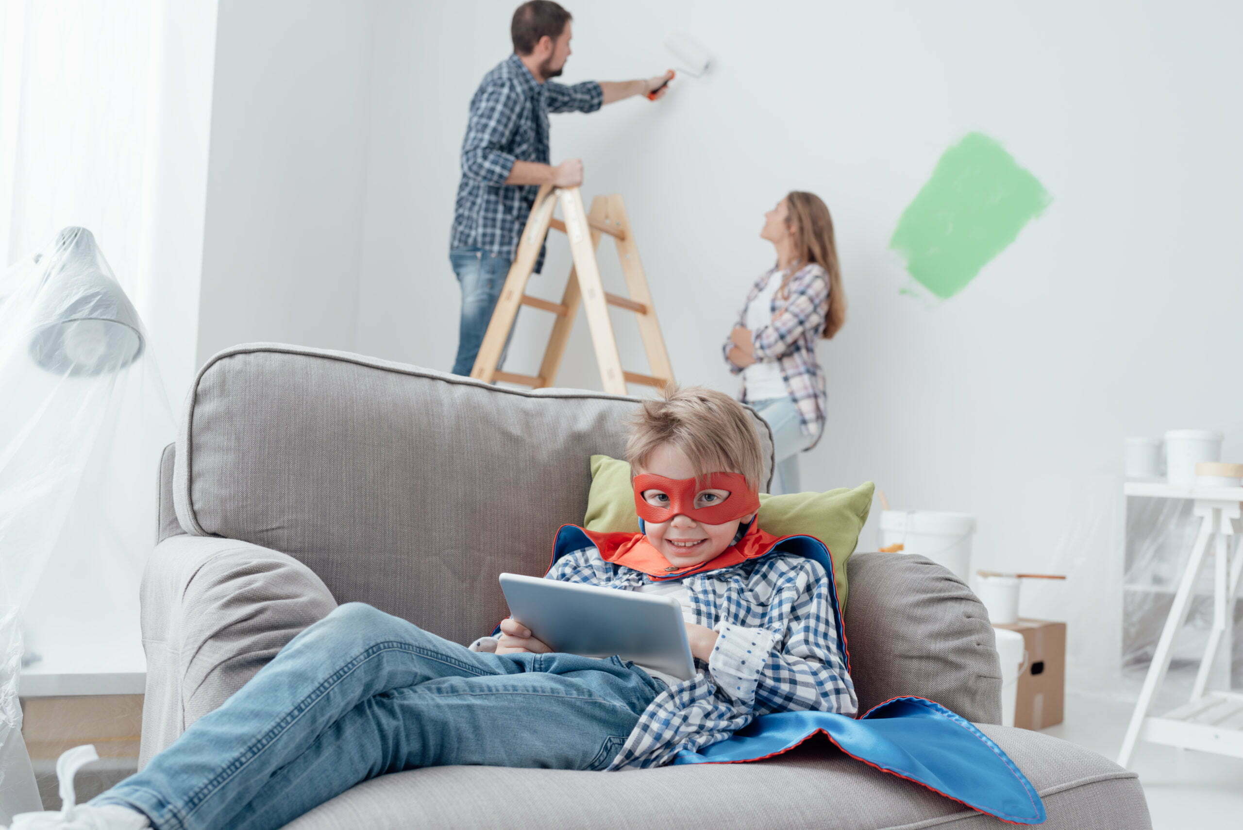 Superhero using a tablet and home makeover